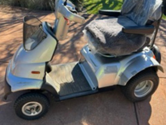 A grey Breeze Scooter with golf bag holder on rear